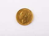 a close up of a gold coin on a white surface
