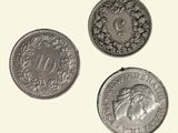 three different types of coins are shown on a white surface