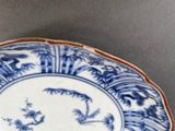 a blue and white plate with a bird design on it