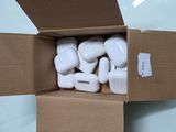 a cardboard box filled with white airpods sitting on top of a table