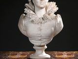 a marble bust of a woman sitting on a table