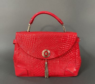 a red handbag with a tassel on the handle