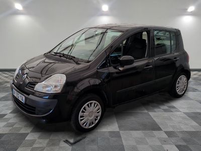 a picture of a small black car parked in a garage