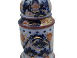 an image of a blue and white jar with flowers on it