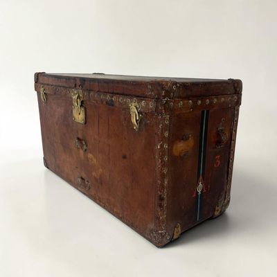 an old trunk sitting on top of a white surface