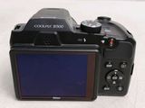a black camera with a blue screen on a table