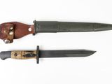 two knives are laying side by side on a white surface
