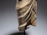 a statue of a woman wrapped in a blanket on top of a wooden stand