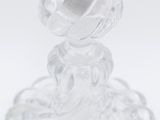 clear glass candle holder with a black candle on top of it