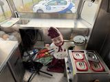 a small child that is standing in the kitchen