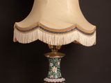 a lamp that is sitting on a table with a lamp shade on it