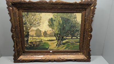 an oil painting of a landscape with trees in a gold frame on a white surface