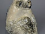 a ceramic sculpture of a monkey sitting on its hind legs