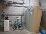a water heater and a water tank in a room