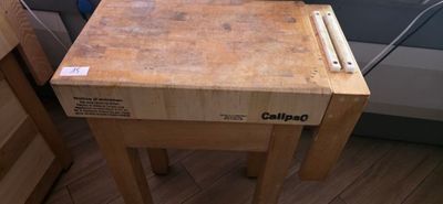 a wooden table with a laptop on top of it