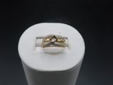 a close up of a ring on a white stand with a black background