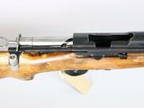 a close up of a rifle on display on a white surface
