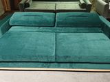 a green couch and a blue chair in a room