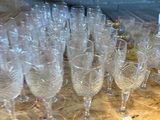 many empty wine glasses lined up on a table