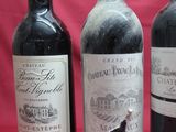three bottles of wine are lined up on a red background