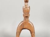 an image of a statue of a woman sitting on top of a wooden stand