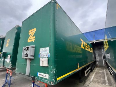 a large green truck that is parked in a parking lot