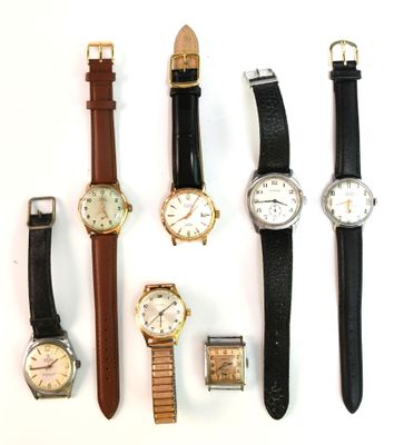 several different types of watches are lined up on a white surface