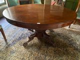 a large wooden table in the middle of a living room