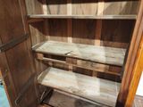 a wooden cabinet with two shelves in it