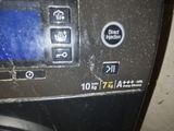 a close up of a washing machine with a clock on it