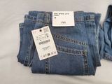 a pair of jeans with a price tag on them