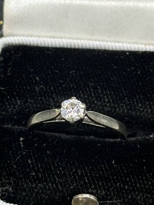 a diamond ring sitting in a box with a ring in it