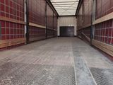 an image of a long empty warehouse with red walls