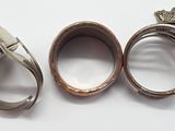 three silver rings with a red bead and a silver ring with a red bead