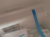 a white refrigerator with a blue tape on the door