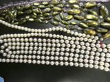 some pearls are laying on top of a black table