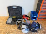 many different types of gas masks on the floor