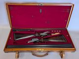 a wooden case with two guns inside of it