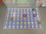 a display case with a lot of disney pin ' s on it