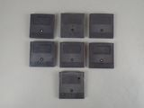 six nintendo game cartridges sitting on top of a white surface