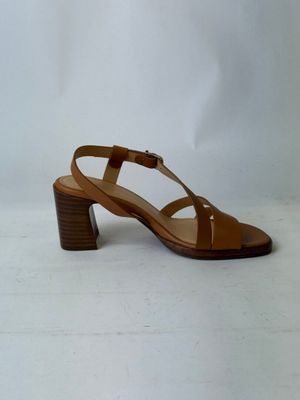 le talon d'une sandale marron pour femme sur fond blanc
