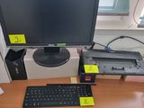 a computer monitor sitting on a desk with a keyboard and mouse