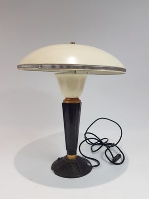une photo d'une lampe de table avec un abat-jour blanc et un pied noir