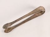 a silver spoon and a spoon rest on a white surface