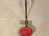 a red object hanging on a hook on the wall