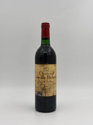 a bottle of wine sitting on top of a white table
