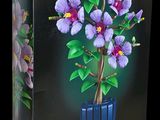a box with a plant in it on a black background
