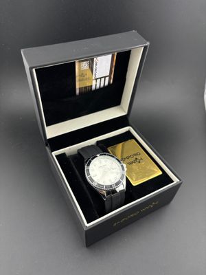 an image of a watch in a box next to a clock