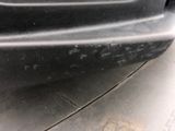 a close up of a car ' s bumper with scratches on it