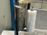 a picture of a machine with a roll of plastic on it